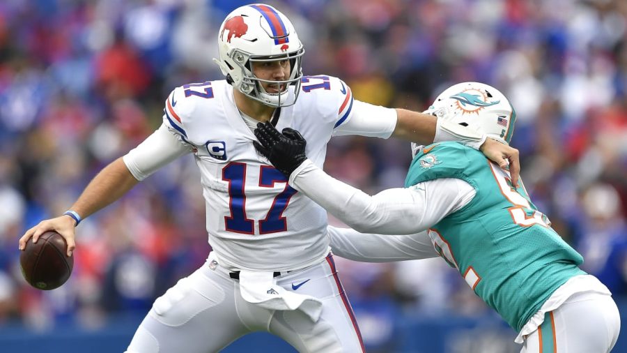 Buffalo Bills quarterback Josh Allen stiff arms Miami Dolphins linebacker Elandon Roberts