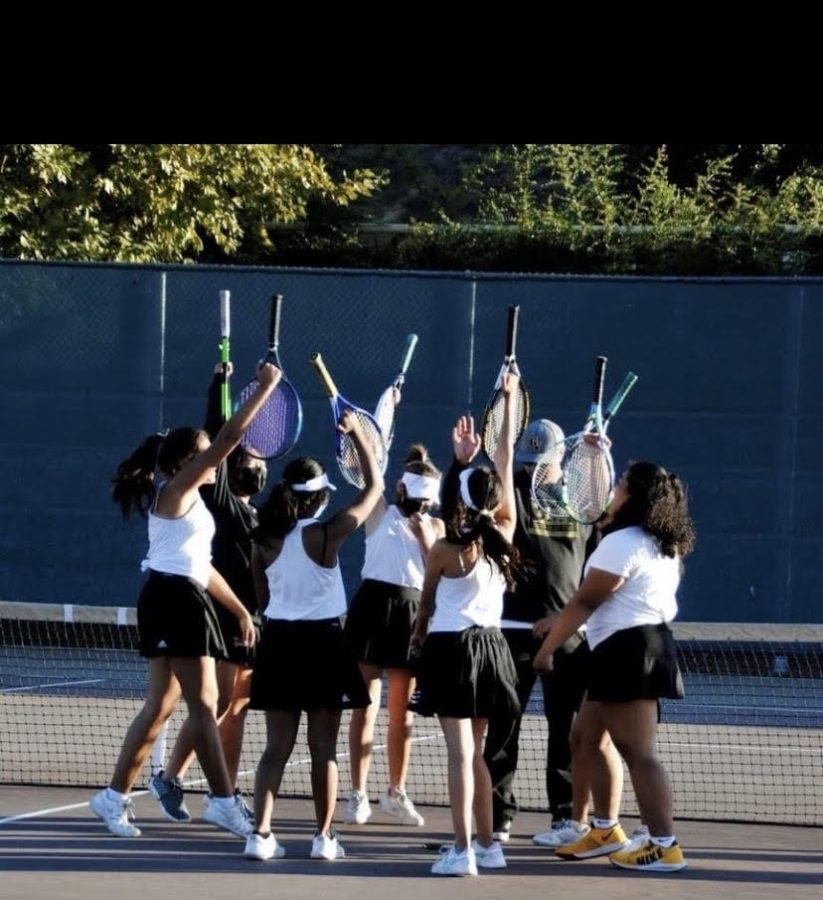 The girls Tennis Team cheering before the match