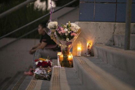 Students and community members place flowers and candles at Helen Bernstein High School where a teenage girl died of an overdose on Thursday, Sept. 15, 2022, in Los Angeles. Authorities said multiple Los Angeles teenagers have overdosed on pills likely laced with fentanyl over the past month, including the 15-year-old girl who died on the high school campus.