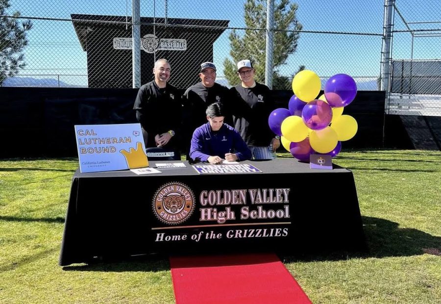 Wyatt (Center) signing his commitment papers on the baseball field surrounded by (left ro right) Principal Sal Frias, Head Coach Adrien Rios, and his father and coach Mike Crosby.