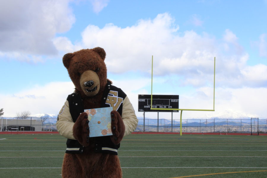 Golden Valley Mascot, Graham Grizzly, holding his beautifully decorated graduation cap!