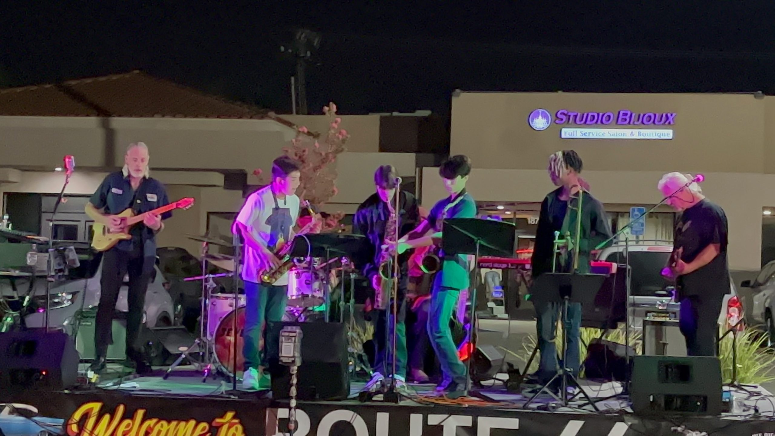 Daniel Spears (Middle in the black shirt with the saxophone in his mouth) playing a saxophone solo accompanied by his band peers, photo taken by Christina Spears on September 16th 2023 at Route 66.