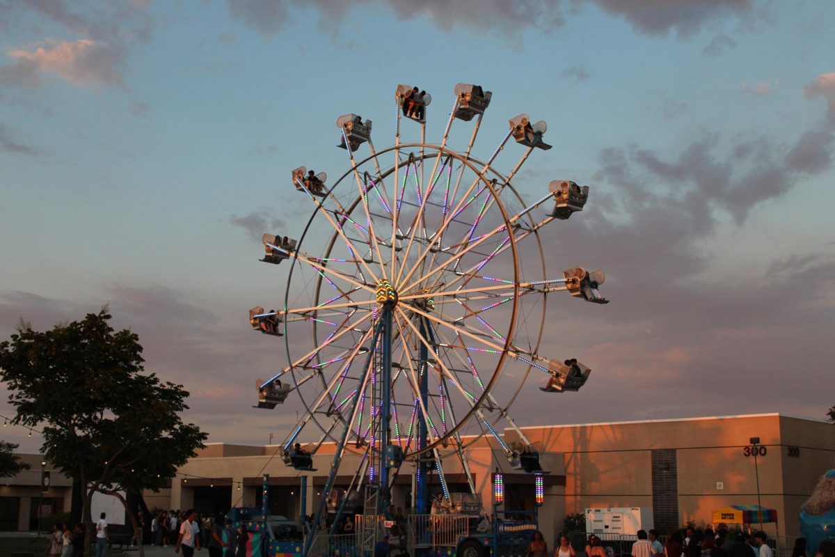 People enjoying the beautiful view of the sunset from the ferris wheel.